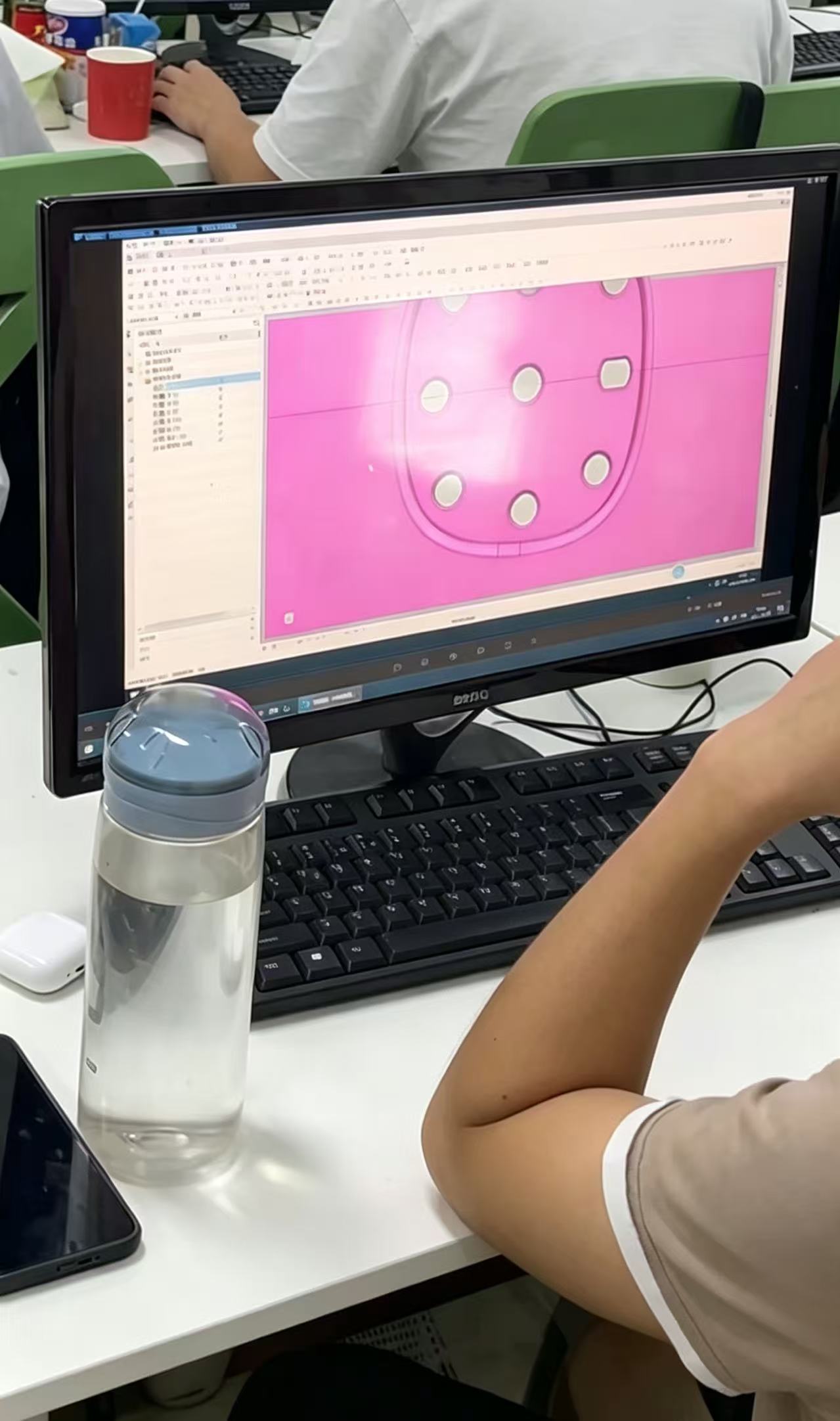Engineer designing custom silicone pet ID tag in CAD software